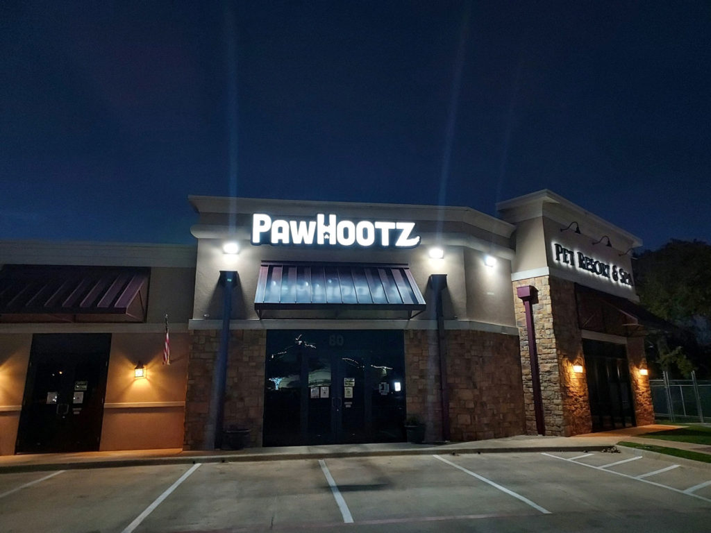 PawHootz Pet Resort building from the outside during the night.